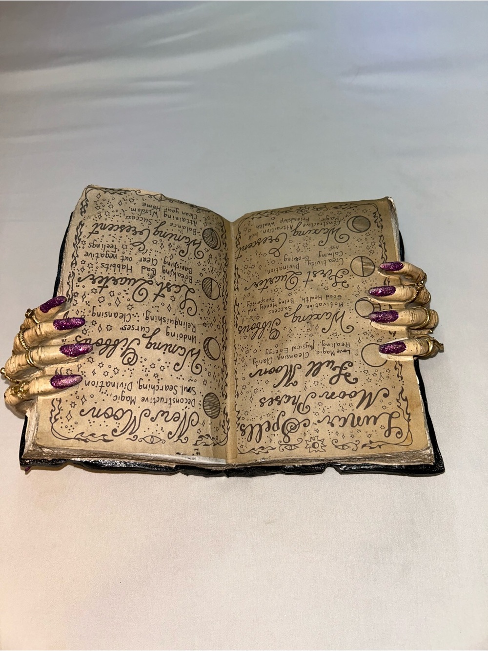Bella Luxx Gold Skeleton Hand Book Holder with Purple Nails